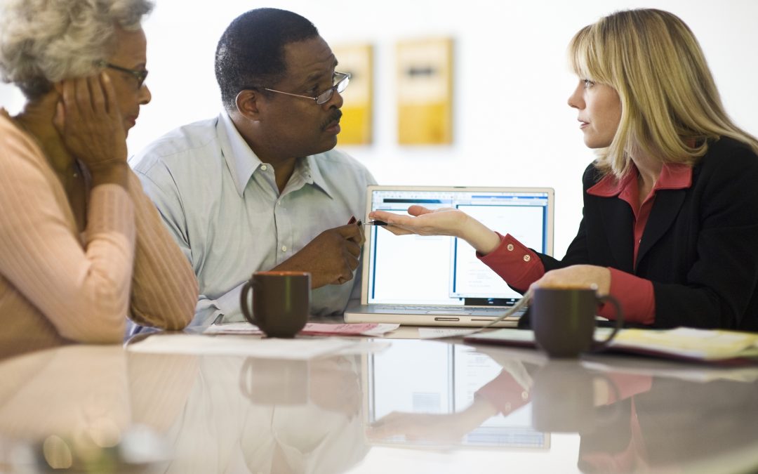 Financial advisors talking with investors.