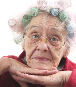 An old lady with hair curlers.