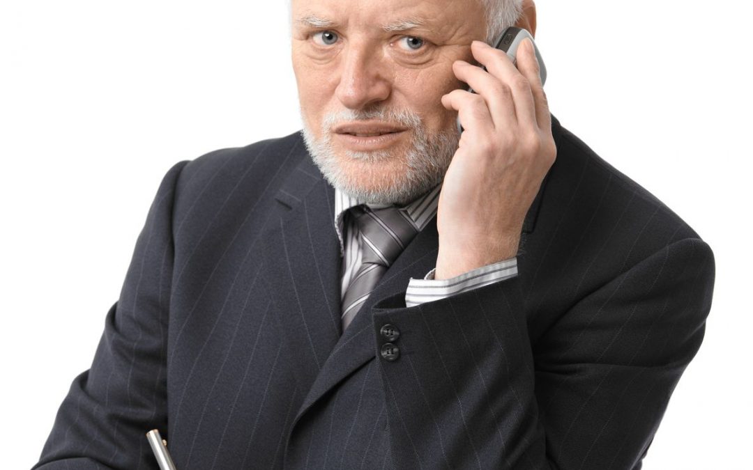 A grim advisor on his cell phone.