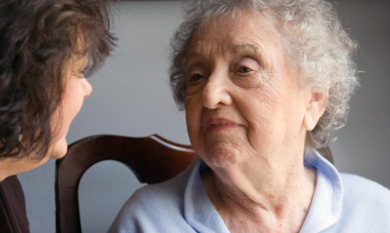 Elder woman speaking with another elder woman