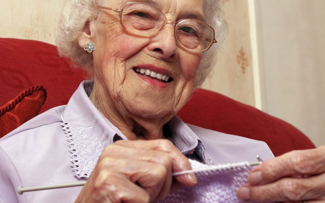 Happy elder woman Knitting