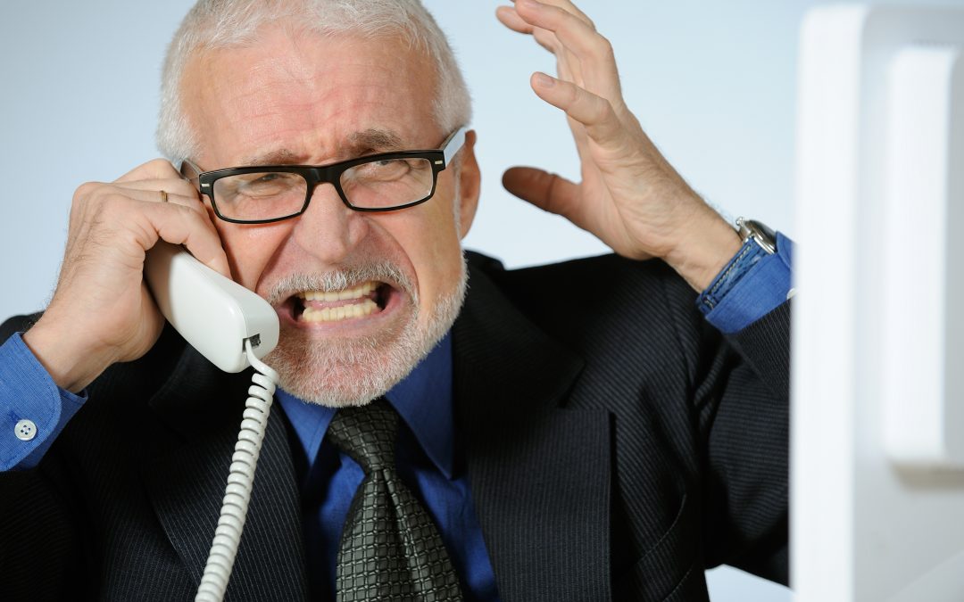 Angry elder businessman on telephone
