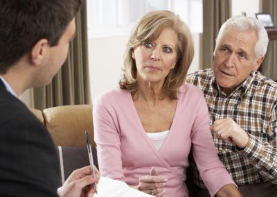Elder couple taking to advisor