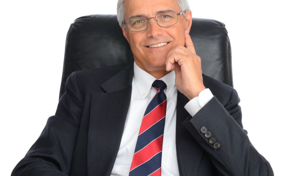 Smiling Businessman At Desk