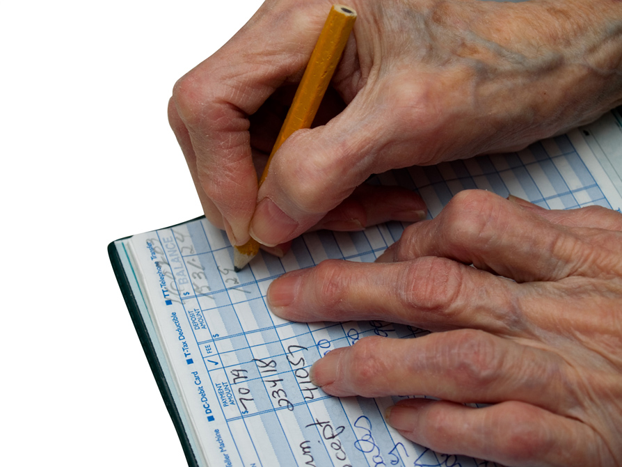 older person writing check