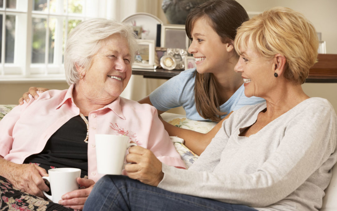 adult daughter with teenage granddaughter visiting grandmother