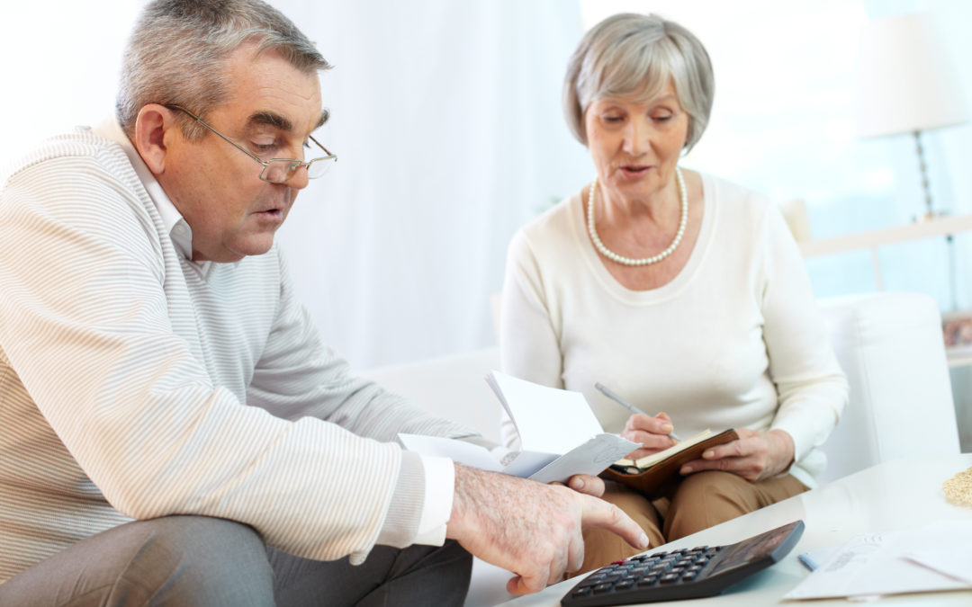 Senior couple counting their expenses