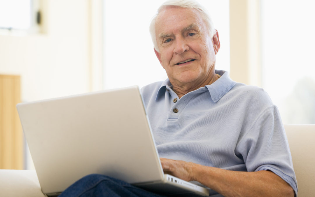 senior,man,laptop,computer,at home,sofa,browsing,surfing,interne