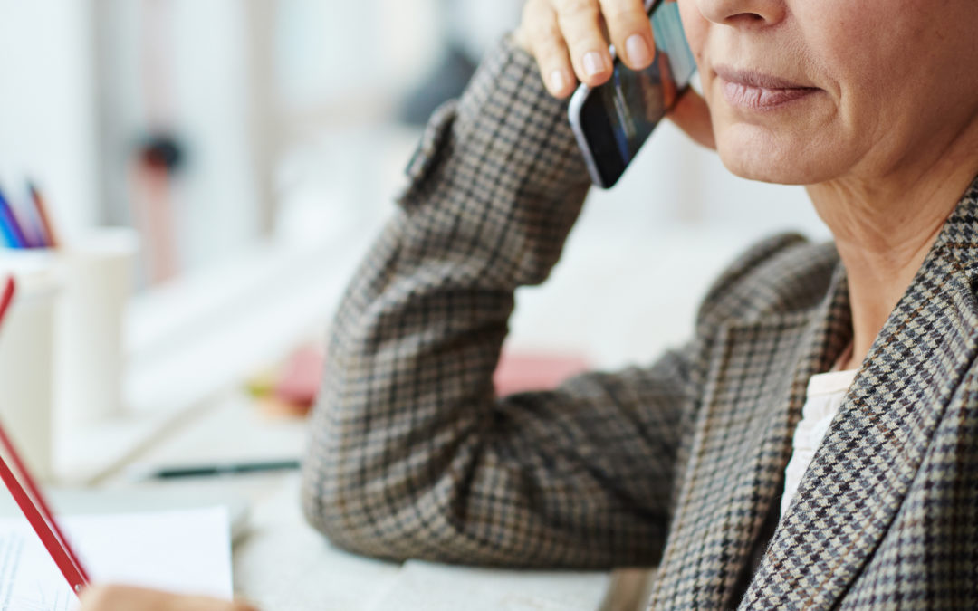 Mature businesswoman speaking on telephone with client