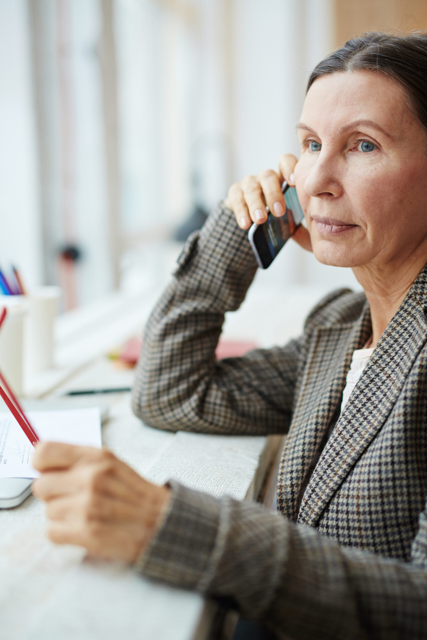 Mature businesswoman speaking on telephone with client